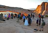 Morning crowds may include a wedding party  - Mesa Arch, Canyonlands National Park, Utah